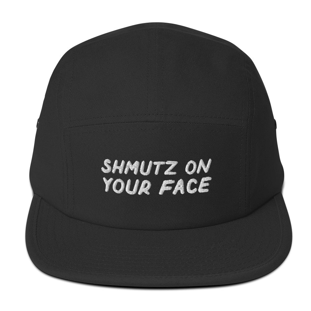 Shmutz on Your Face 5-panel cap in Black, front view with embroidered phrase