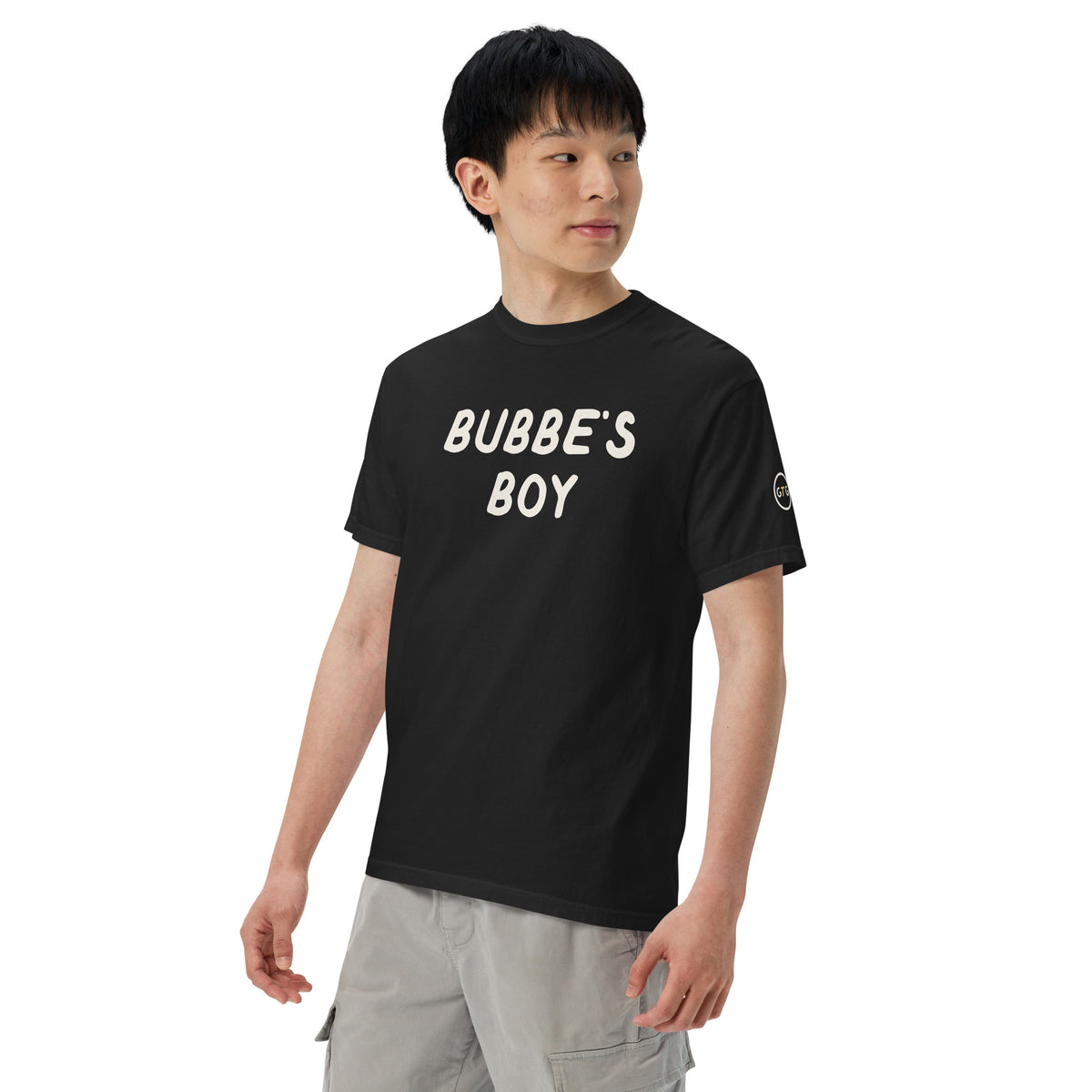 Model wearing the Good Thank God Bubbe's Boy T-shirt in Black, left front view showing the GTG sleeve badge