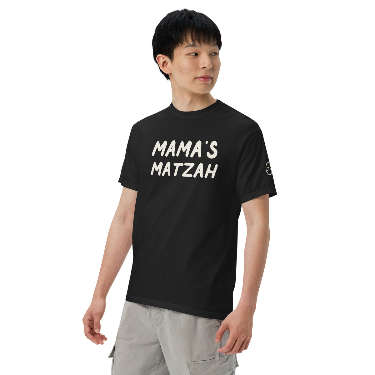 Model wearing the Good Thank God Mama's Matzah T-shirt in Black, left front view showing the GTG sleeve badge