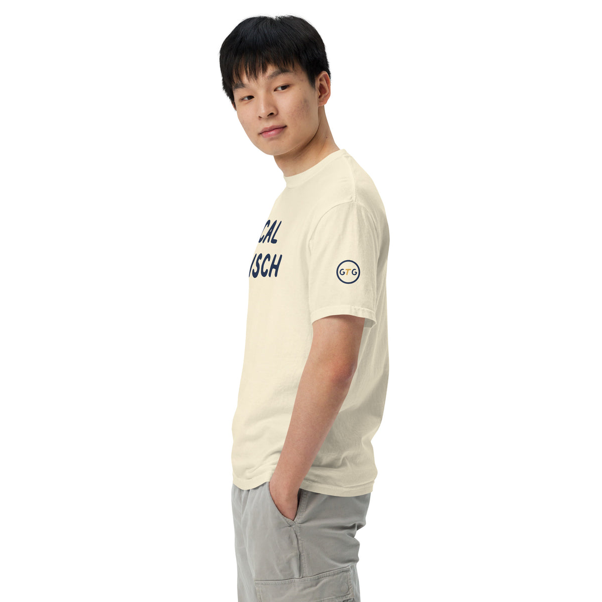 Model wearing the Good Thank God Local Mensch T-shirt in Ivory, left side view showing the GTG sleeve badge