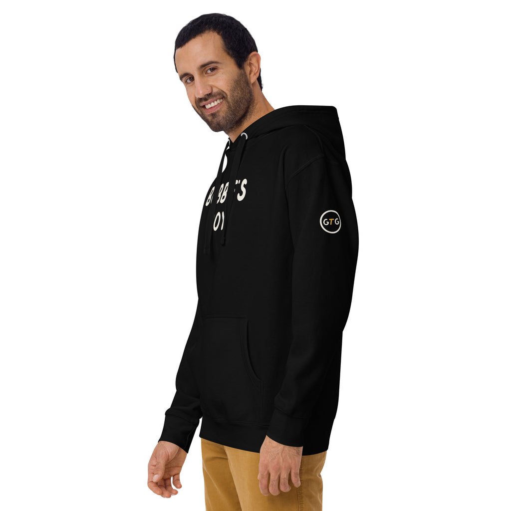 Model wearing the Good Thank God Bubbe's Boy hoodie in Black, left front view showing the GTG sleeve badge