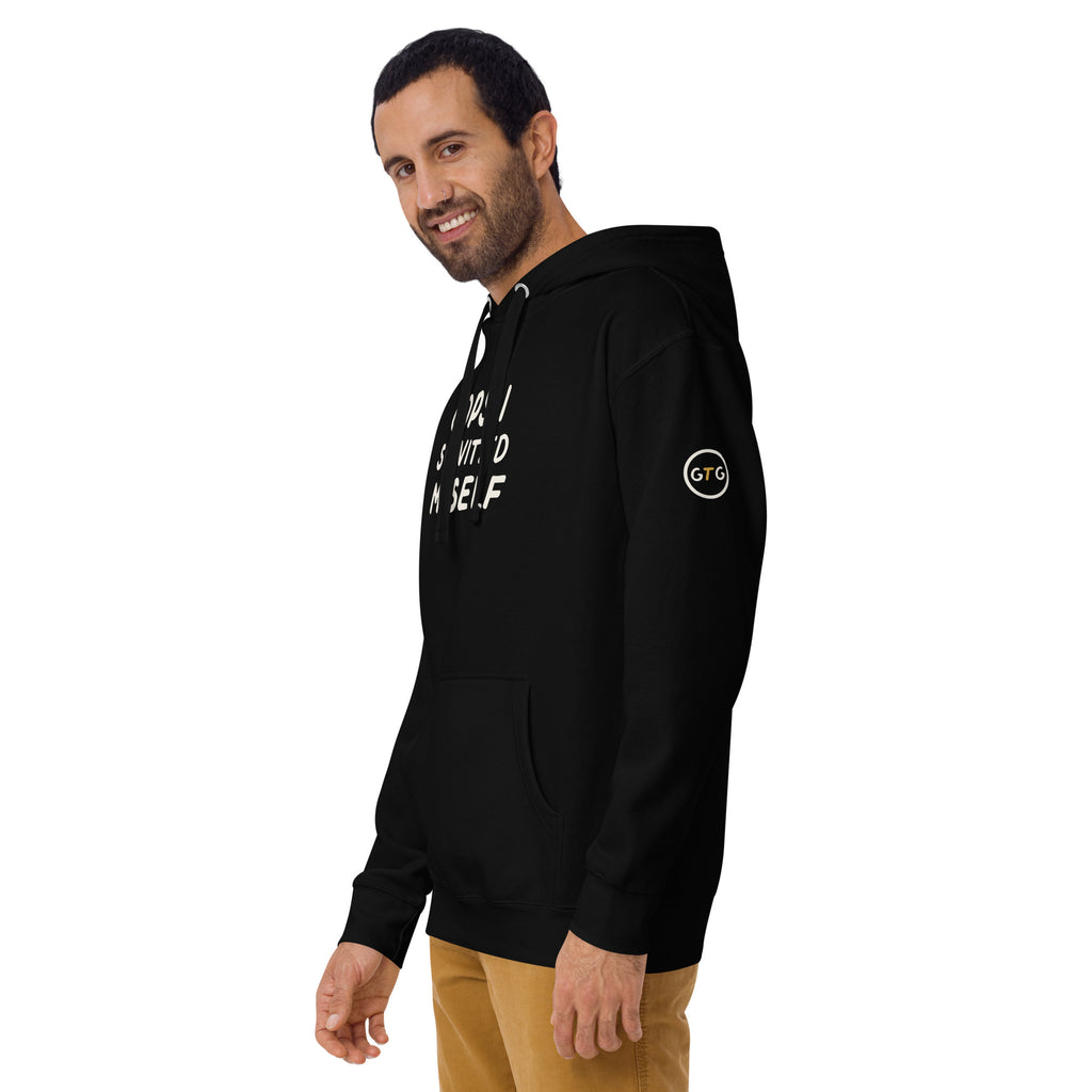 Model wearing the Good Thank God Oops I Schvitz'd Myself hoodie in Black, left front view showing the GTG sleeve badge