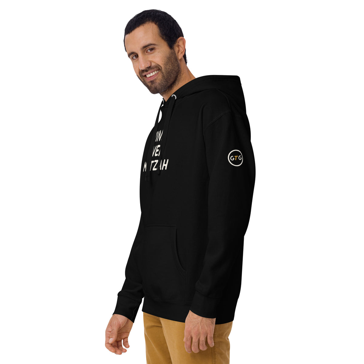 Model wearing the Good Thank God Mind Over Matzah hoodie in Black, left front view showing the GTG sleeve badge