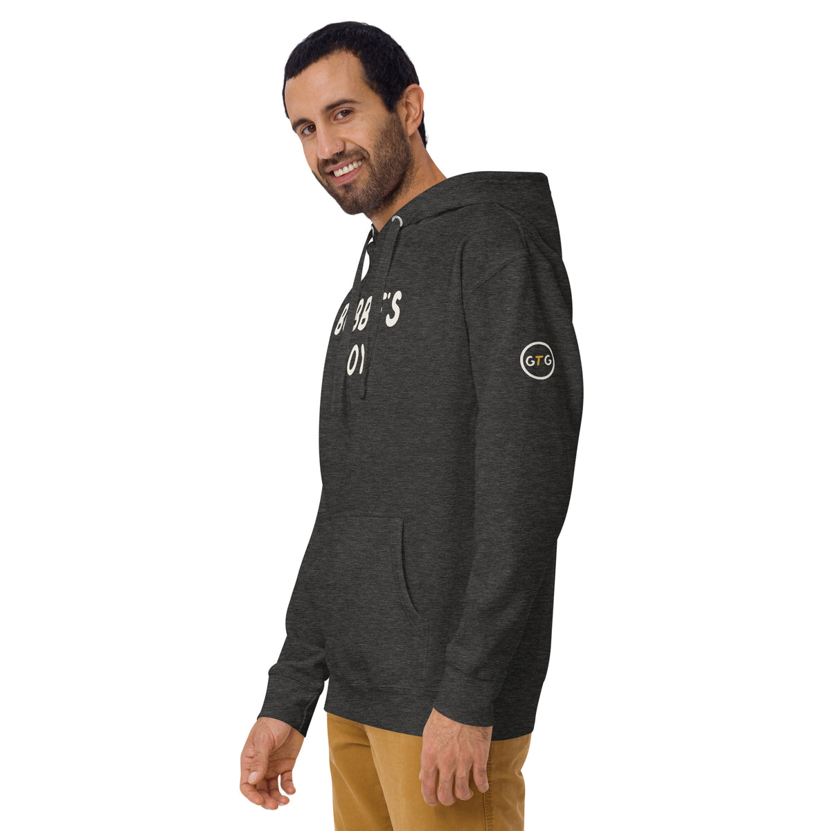 Model wearing the Good Thank God Bubbe's Boy hoodie in Charcoal Heather, left front view showing the GTG sleeve badge