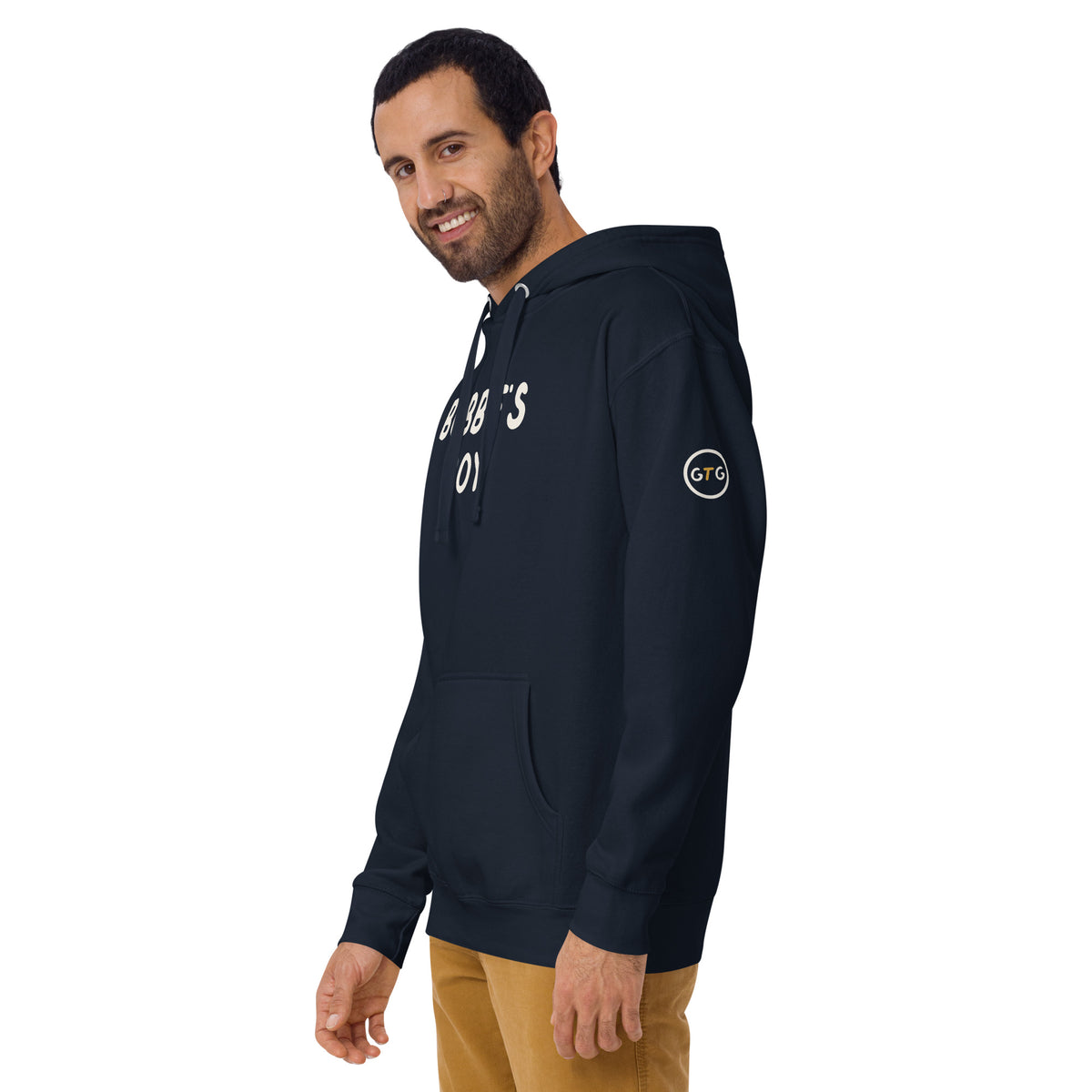 Model wearing the Good Thank God Bubbe's Boy hoodie in Navy Blazer, left front view showing the GTG sleeve badge