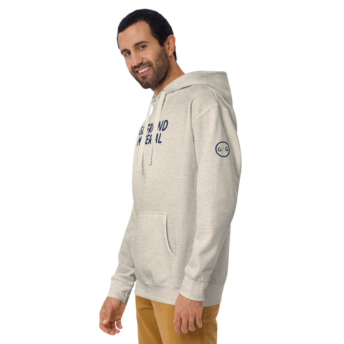 Model wearing the Good Thank God Goyfriend Material hoodie in Oatmeal Heather, left front view showing the GTG sleeve badge